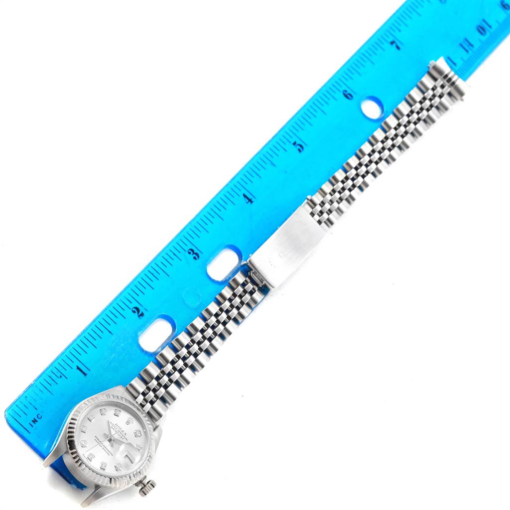 The image shows a Rolex Datejust 79174 Women's Stainless Steel Silver Dial 79174 Women's Stainless Steel Silver Dial watch laid flat beside a ruler with its face, bezel, and bracelet visible.