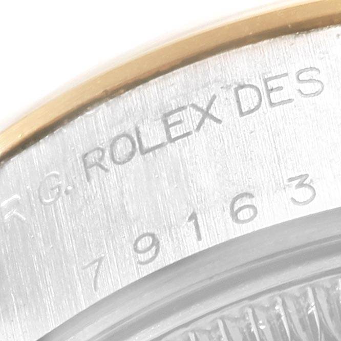 This image shows an angled close-up of the engraved case back of a Rolex Datejust 79163 Women's Steel and Gold (two tone) White Dial 79163 Women's Steel and Gold (two tone) White Dial watch.