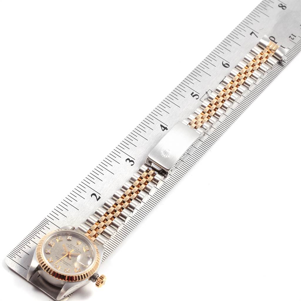 The image shows a Rolex Datejust 69173 Women's Stainless Steel Grey Dial 69173 Women's Stainless Steel Grey Dial watch with a measuring scale, displaying the face, case, and bracelet.