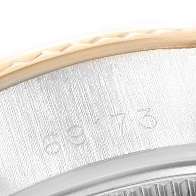 The image shows a close-up of the bezel and part of the casing of a Rolex Datejust 69173 Women's Stainless Steel Grey Dial 69173 Women's Stainless Steel Grey Dial watch, with visible engravings.