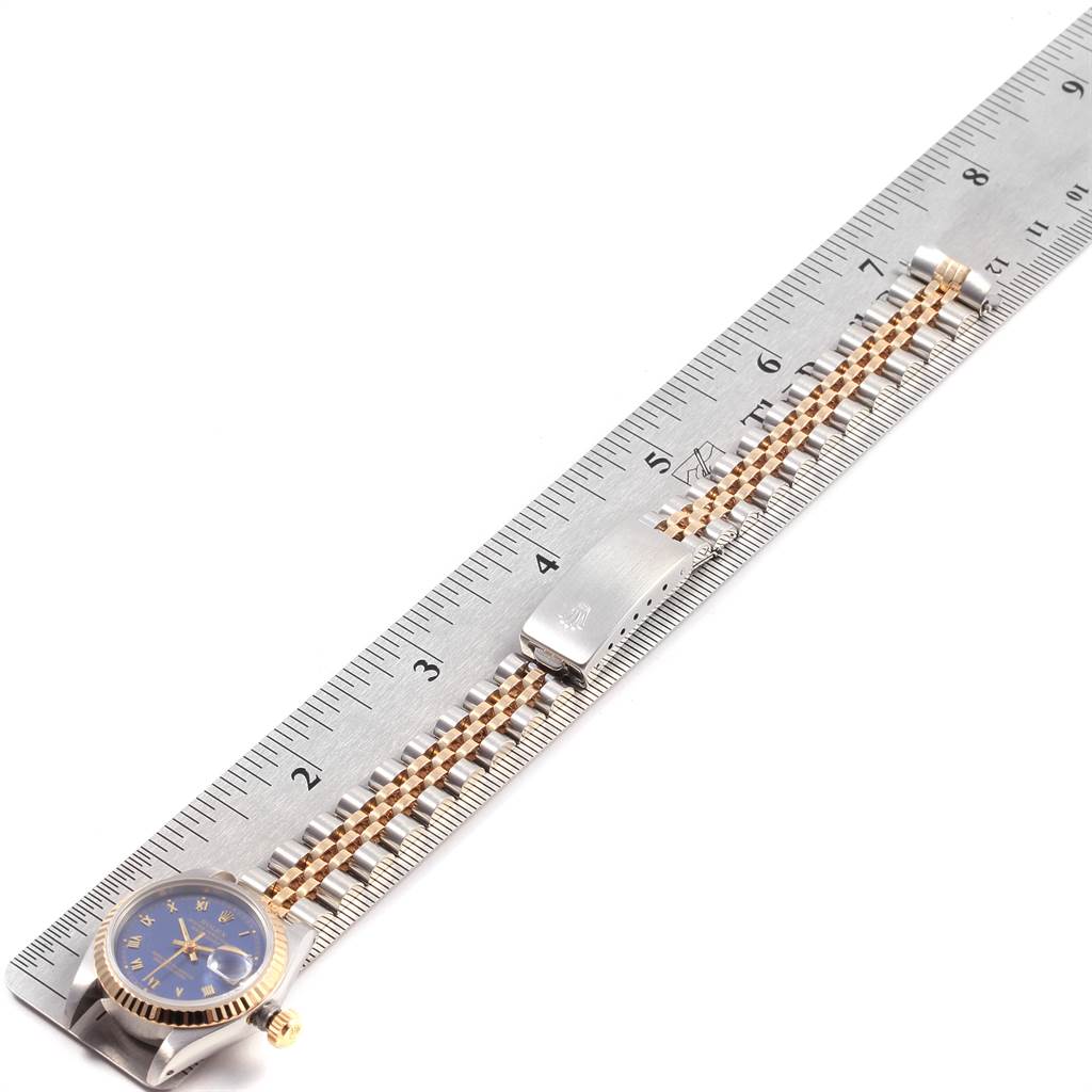 The image shows a Rolex Datejust 69173 Women
s Stainless Steel Blue Dial 69173 Women
s Stainless Steel Blue Dial watch laid flat against a ruler, displaying the watch face and the entire bracelet including the clasp.