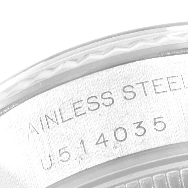 The image shows a close-up of the serial number and "STAINLESS STEEL" engraving on the casing of a Rolex Datejust 69174 Women
s Stainless Steel Blue Dial 69174 Women
s Stainless Steel Blue Dial watch.