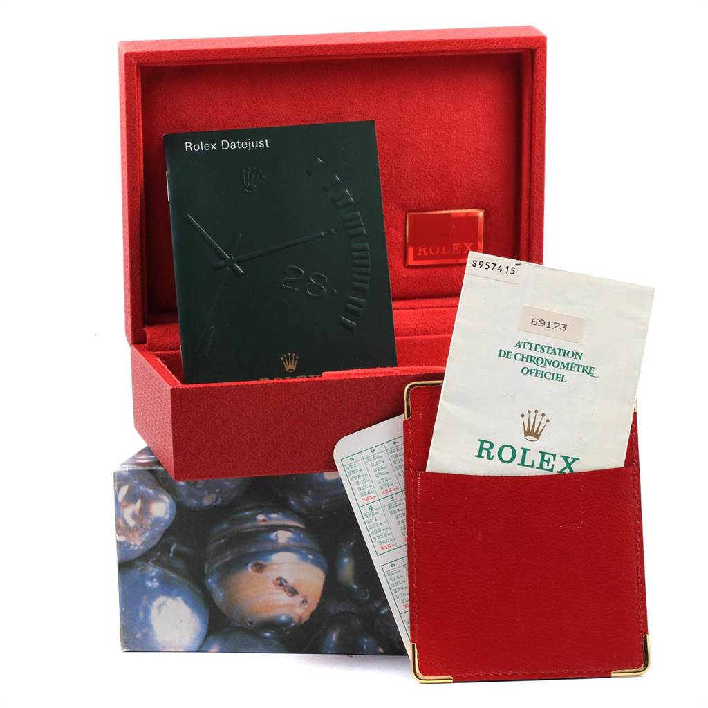 The image shows the packaging and accessories for a Rolex Datejust 69173 Women
s Stainless Steel Beige Dial 69173 Women
s Stainless Steel Beige Dial watch, including the box, booklet, and official certification documents.