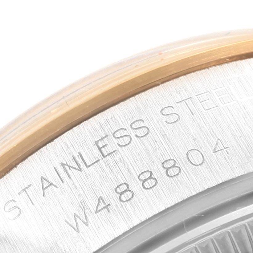 This image shows a close-up of the side of a Rolex Datejust 69163 Women
s Steel and Gold (two tone) Silver Dial 69163 Women
s Steel and Gold (two tone) Silver Dial watch, highlighting the stainless steel part with engraved text and a partial view of the bezel.