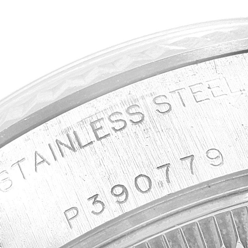 The image shows a close-up of the case back of a Rolex Datejust 79174 Women
s Stainless Steel Silver Dial 79174 Women
s Stainless Steel Silver Dial, highlighting the "STAINLESS STEEL" inscription and serial number.