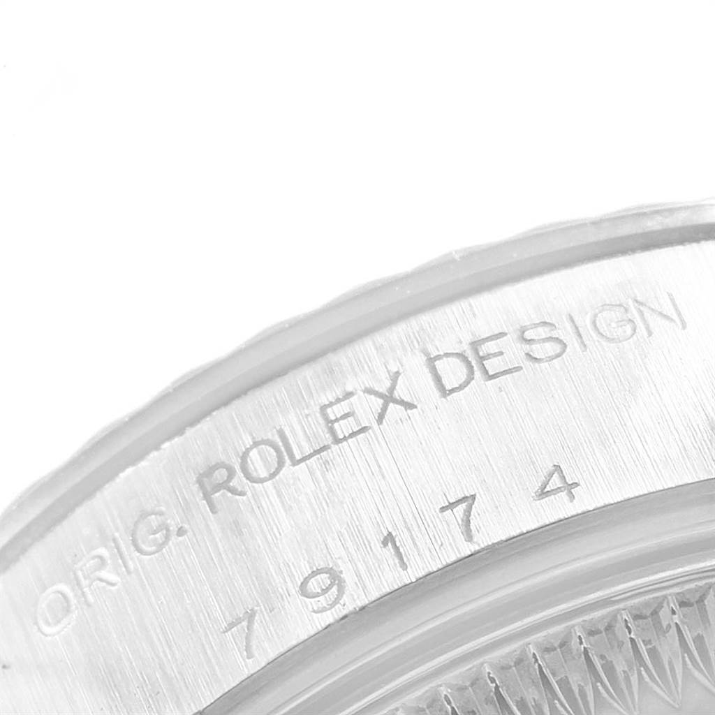 This close-up image of a Rolex Datejust 79174 Women
s Stainless Steel Silver Dial 79174 Women
s Stainless Steel Silver Dial shows the engraved text "ORIG. ROLEX DESIGN" and the serial number.