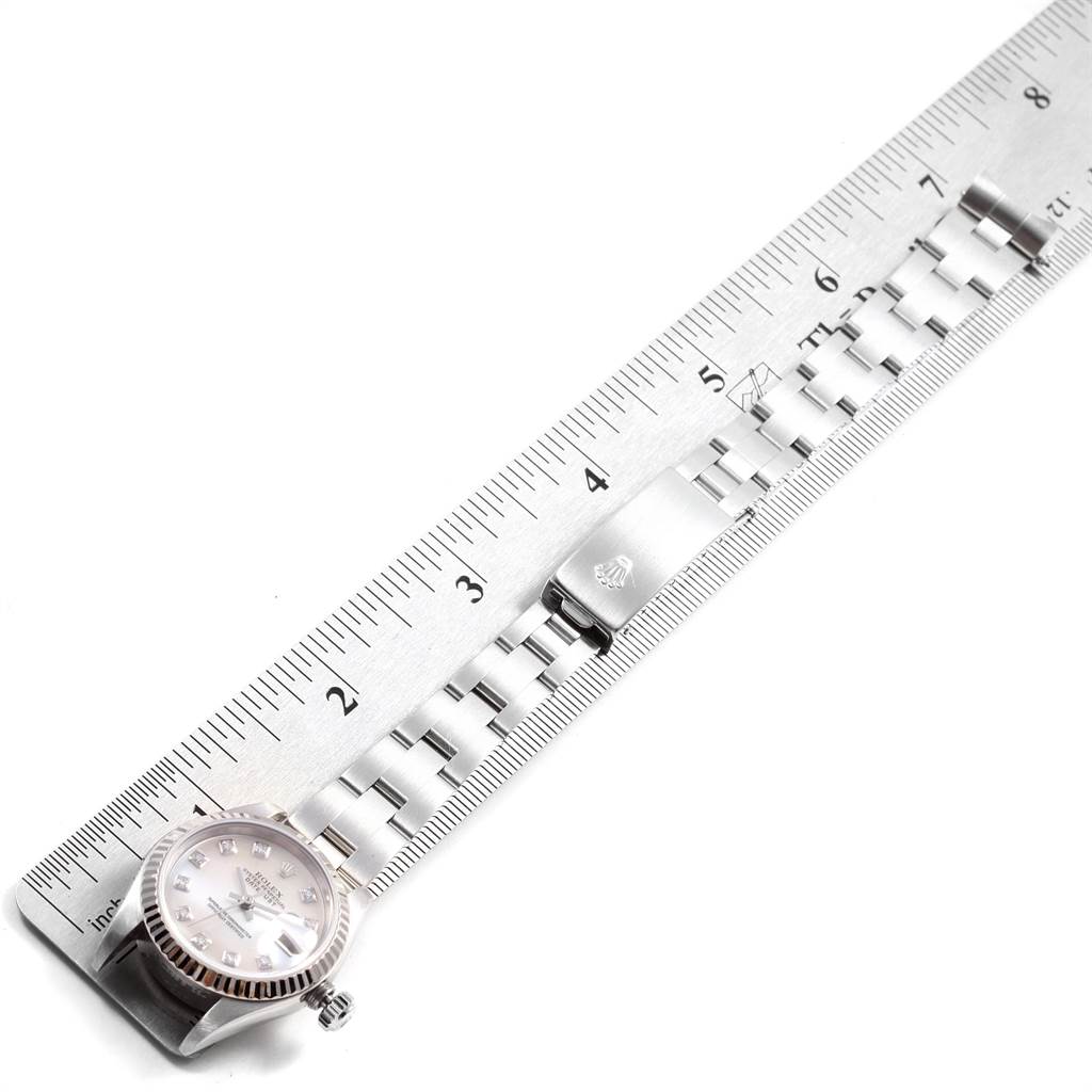 This image shows the Rolex Datejust Women
s Stainless Steel Mother of Pearl Dial Women
s Stainless Steel Mother of Pearl Dial watch laid flat, measured alongside a ruler, highlighting the face and bracelet.