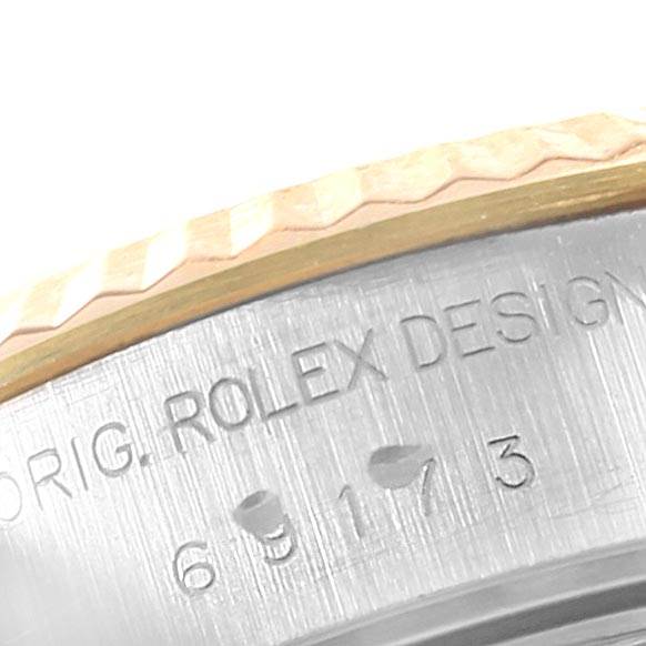 The image shows a partial view of the bezel and engraved case side of a Rolex Datejust 69173 Women's Stainless Steel White Dial 69173 Women's Stainless Steel White Dial watch.
