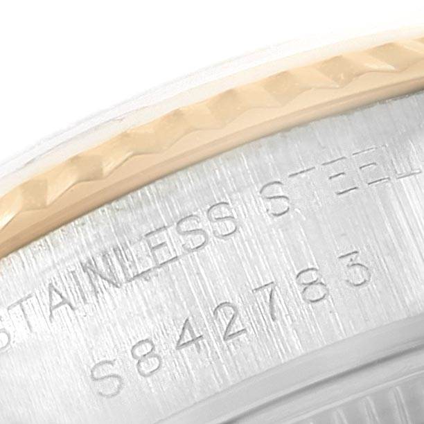 The image shows a close-up of the engraved stainless steel case and fluted bezel of a Rolex Datejust 69173 Women's Stainless Steel Champagne Dial 69173 Women's Stainless Steel Champagne Dial watch.