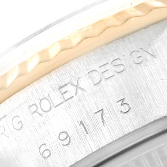 The image shows a close-up of the serial number and part of the bezel of a Rolex Datejust 69173 Women's Stainless Steel Champagne Dial 69173 Women's Stainless Steel Champagne Dial watch.