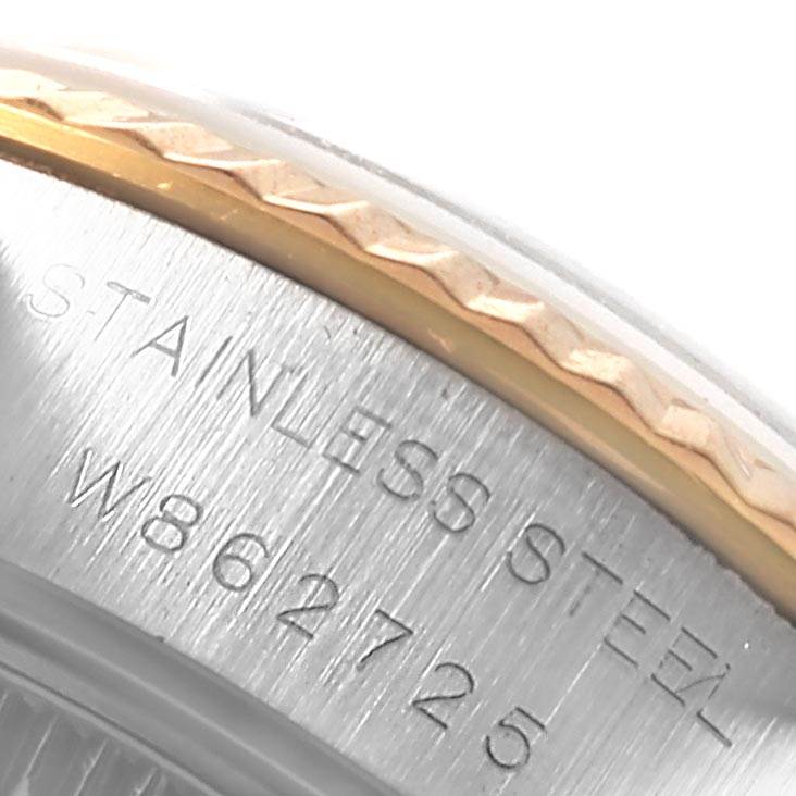 The image shows a close-up view of the serial number and the "STAINLESS STEEL" engraving on the case of a Rolex Datejust 69173 Women's Stainless Steel White Dial 69173 Women's Stainless Steel White Dial watch.