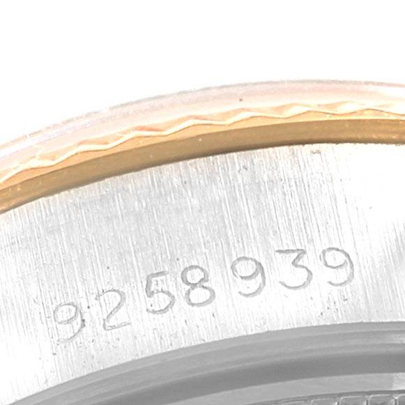 The close-up shows a serial number etched on the side of a Rolex Datejust 69173 Women's Stainless Steel Champagne Dial 69173 Women's Stainless Steel Champagne Dial model watch case.