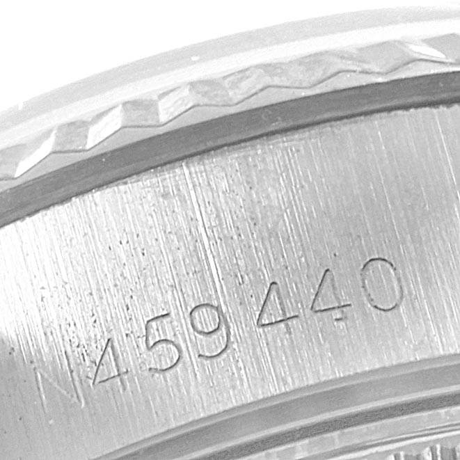 The image shows a close-up of the serial number engraving and the edge of the bezel of a Rolex Datejust 69174 Women's Stainless Steel Silver Dial 69174 Women's Stainless Steel Silver Dial watch.