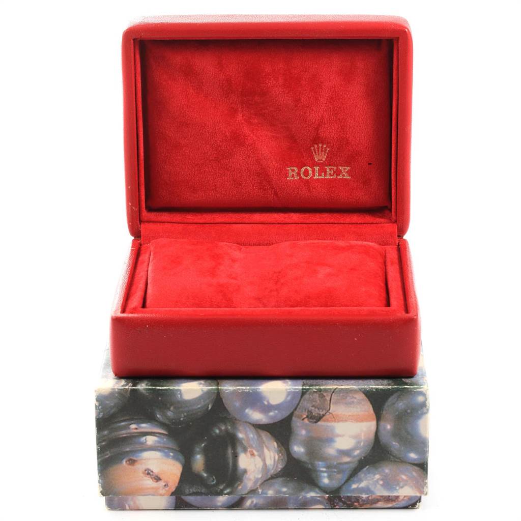 This image shows a red Rolex Datejust 79173 Women
s Stainless Steel Champagne Dial 79173 Women
s Stainless Steel Champagne Dial watch box, with the lid open, displaying the cushion and logo inside.