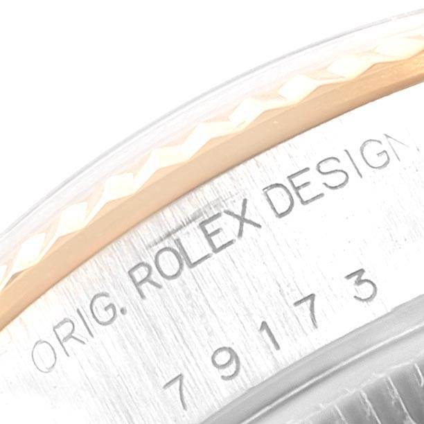 This image shows a close-up of the side of a Rolex Datejust 79173 Women
s Stainless Steel Champagne Dial 79173 Women
s Stainless Steel Champagne Dial model, highlighting the engraved "ORIG. ROLEX DESIGN" and model number.