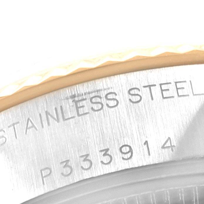 The image shows a close-up of the case back edge of a Rolex Datejust 79173 Women
s Stainless Steel Champagne Dial 79173 Women
s Stainless Steel Champagne Dial watch, highlighting the stainless steel text and serial number.
