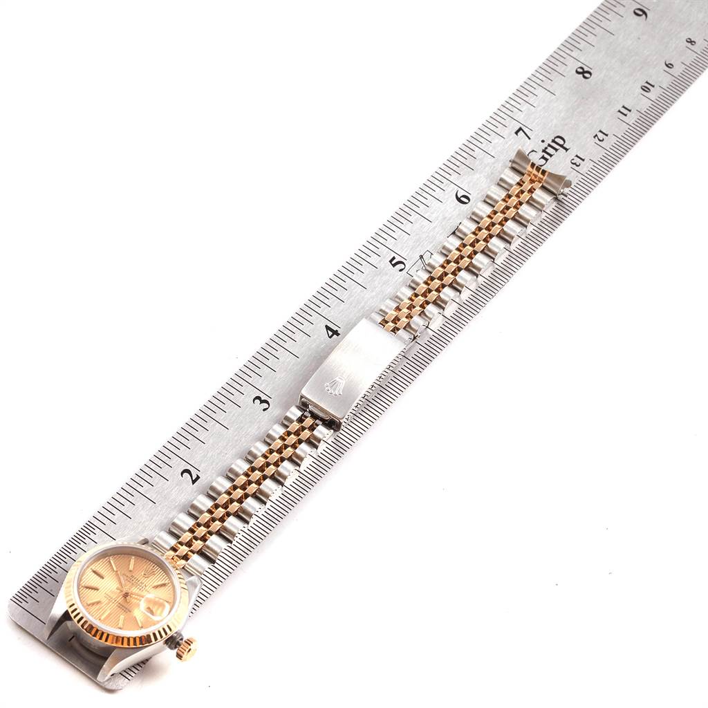 This image shows the Rolex Datejust 69173 Women's Stainless Steel Champagne Dial 69173 Women's Stainless Steel Champagne Dial watch laid flat, ruler for scale, displaying the face, bracelet, and clasp.