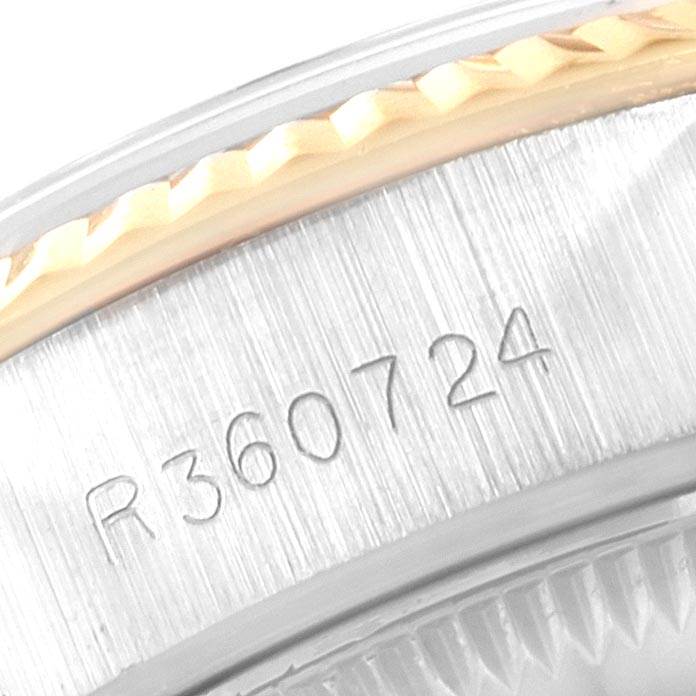 This close-up image shows the serial number engraved on the case of a Rolex Datejust 69173 Women's Stainless Steel Champagne Dial 69173 Women's Stainless Steel Champagne Dial watch.
