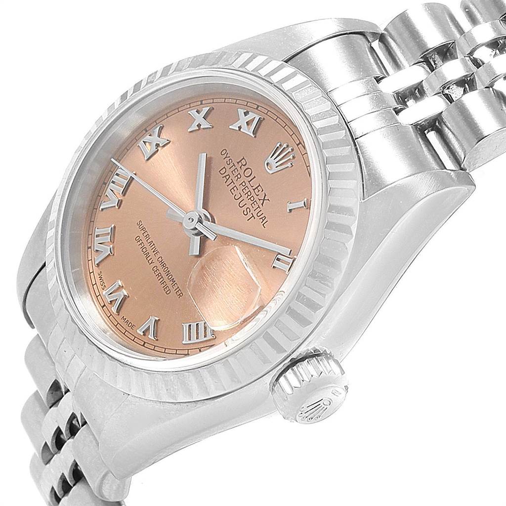 The image shows a side-angle view of a Rolex Datejust 79174 Women
s Stainless Steel Pink Dial 79174 Women
s Stainless Steel Pink Dial watch featuring its crown, bezel, bracelet, and pink dial.