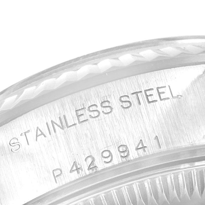 The image shows a close-up of the stainless steel case back, with inscriptions, of a Rolex Datejust 79174 Women
s Stainless Steel Pink Dial 79174 Women
s Stainless Steel Pink Dial watch.