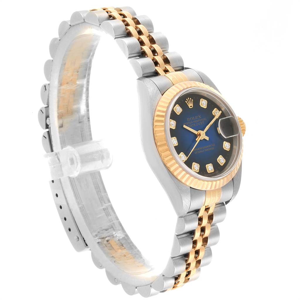 The image shows a side-angle view of a Rolex Datejust 79173 Women's Steel and Gold (two tone) Blue Dial 79173 Women's Steel and Gold (two tone) Blue Dial watch, highlighting its two-tone bracelet, fluted bezel, and diamond-accented dial.