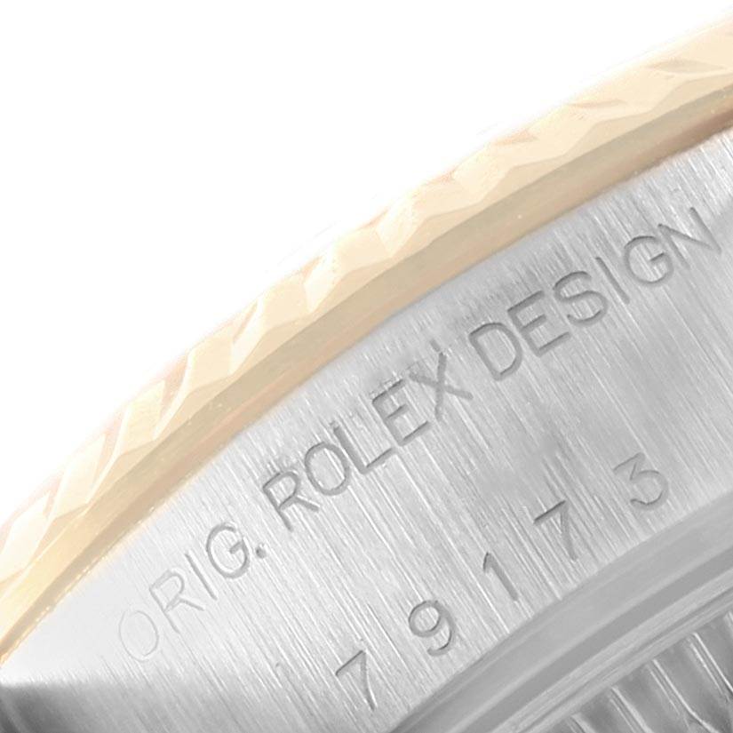 This close-up image shows the engraved bezel and case side of a Rolex Datejust 79173 Women's Steel and Gold (two tone) Blue Dial 79173 Women's Steel and Gold (two tone) Blue Dial model watch.