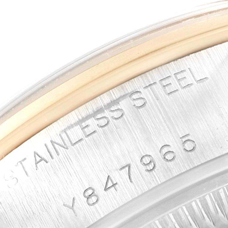 The image shows a close-up of the stainless steel casing and serial number of a Rolex Datejust 79163 Women's Steel and Gold (two tone) Silver Dial 79163 Women's Steel and Gold (two tone) Silver Dial watch.