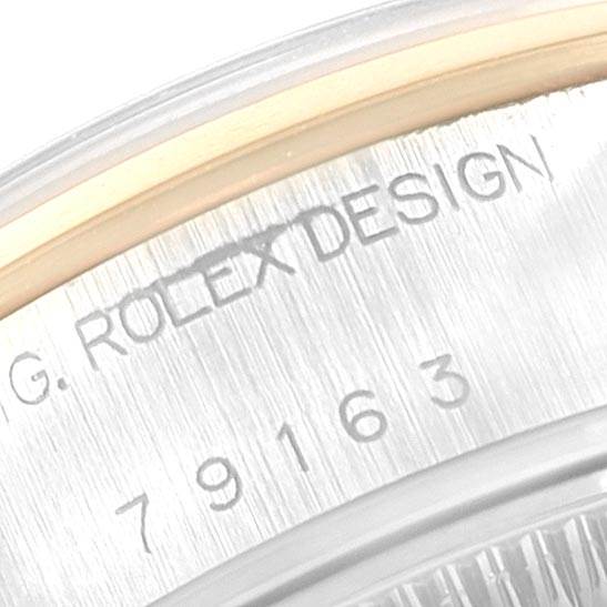 This close-up image shows the engraved side of the bezel and case of a Rolex Datejust 79163 Women's Steel and Gold (two tone) Silver Dial 79163 Women's Steel and Gold (two tone) Silver Dial watch.