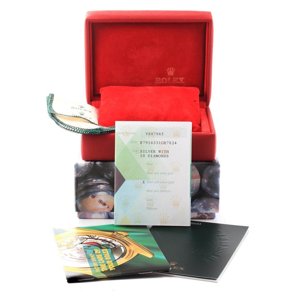 The image shows a Rolex Datejust 79163 Women's Steel and Gold (two tone) Silver Dial 79163 Women's Steel and Gold (two tone) Silver Dial model box and accompanying documents from an angled front view.