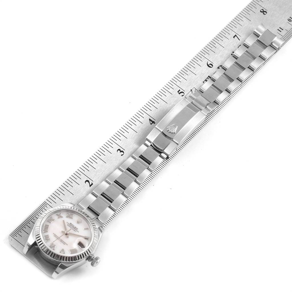 The image shows a horizontally positioned Rolex Datejust 178274 Women
s Stainless Steel Mother of Pearl Dial 178274 Women
s Stainless Steel Mother of Pearl Dial watch with a stainless steel band, adjacent to a ruler for scale.