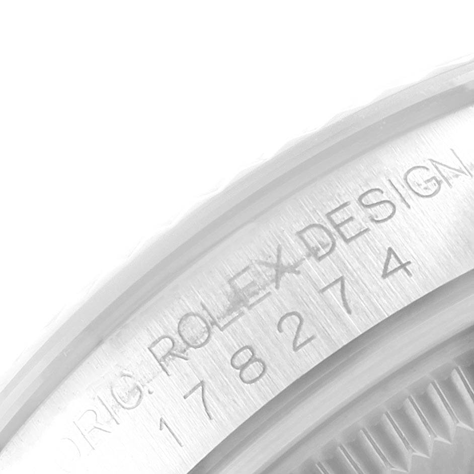 This image shows a close-up of the engraved serial number and text on the case rim of a Rolex Datejust 178274 Women
s Stainless Steel Mother of Pearl Dial 178274 Women
s Stainless Steel Mother of Pearl Dial watch.