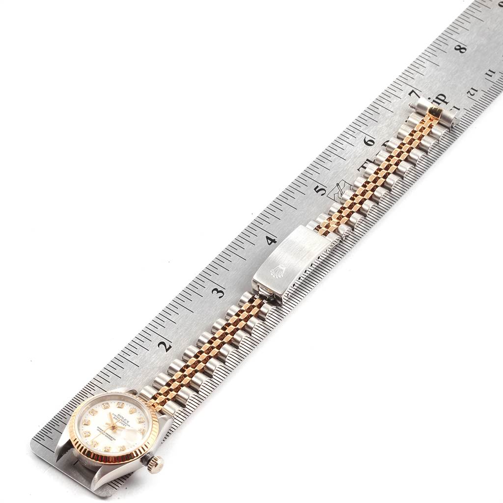 The Rolex Datejust 79173 Women's Steel and Gold (two tone) White Dial 79173 Women's Steel and Gold (two tone) White Dial watch is shown from a top-down angle, displaying its face, bracelet, and clasp.