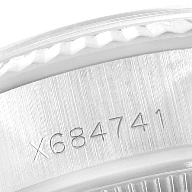 The image shows a close-up of the case side and fluted bezel of the Rolex Datejust 69174 Women's Stainless Steel Silver Dial 69174 Women's Stainless Steel Silver Dial watch, displaying a serial number.