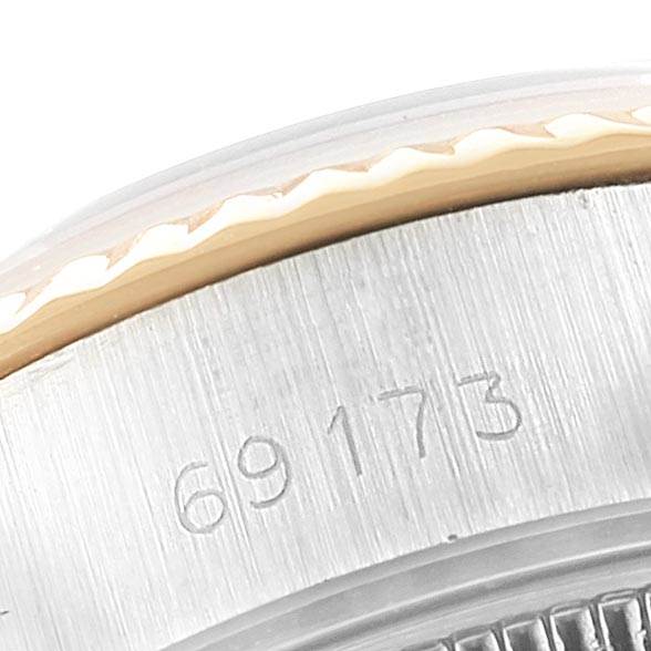 This close-up image of a Rolex Datejust 69173 Women's Stainless Steel Silver Dial 69173 Women's Stainless Steel Silver Dial shows the watch's model number 69173 and the edge of its bezel.