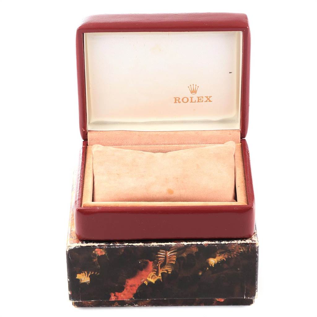 This image shows an open Rolex Datejust 69173 Women's Stainless Steel Silver Dial 69173 Women's Stainless Steel Silver Dial watch box with a cushion inside, placed on a decorative outer box.