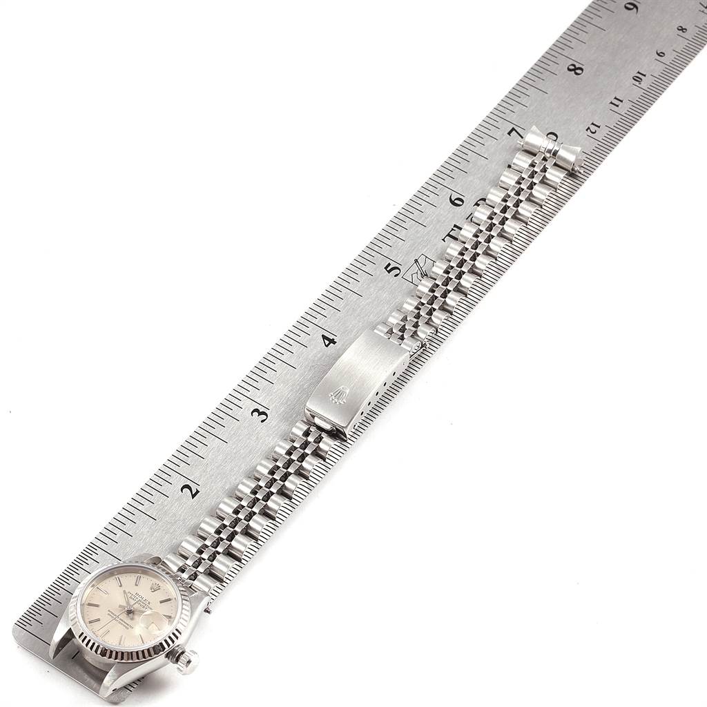 This image shows a Rolex Datejust 69174 Women's Stainless Steel Silver Dial 69174 Women's Stainless Steel Silver Dial watch face, bracelet, and folding clasp measured against a metal ruler.