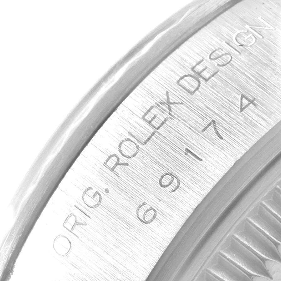 This close-up image of a Rolex Datejust 69174 Women's Stainless Steel Silver Dial 69174 Women's Stainless Steel Silver Dial watch shows the engraved text on its case edge.