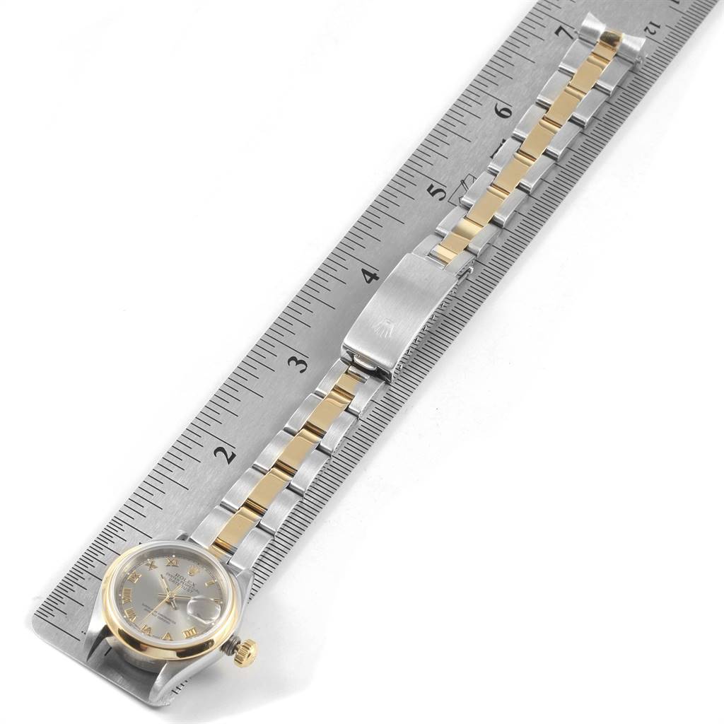 The image shows a Rolex Datejust 69163 Women's Steel and Gold (two tone) Grey Dial 69163 Women's Steel and Gold (two tone) Grey Dial watch laid flat on a ruler, displaying its face, band, and clasp.