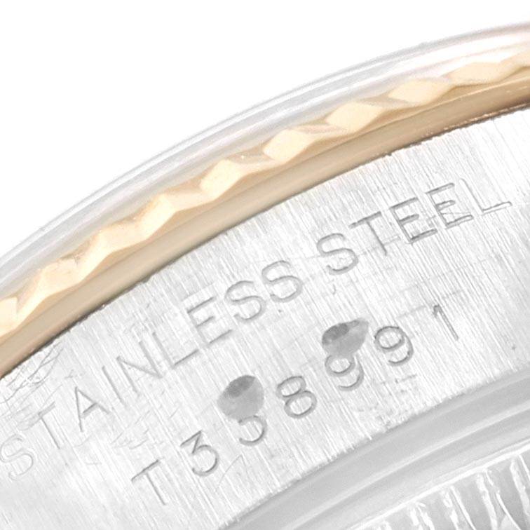 This close-up image captures the engraved stainless steel case and fluted bezel of a Rolex Datejust 69173 Women's Steel and Gold (two tone) Blue Dial 69173 Women's Steel and Gold (two tone) Blue Dial watch.