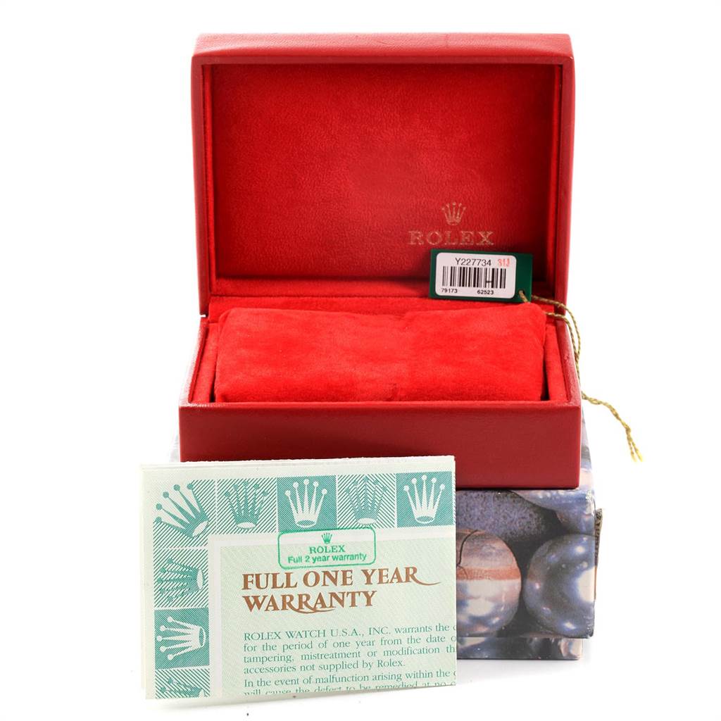 The image shows a Rolex Datejust 79173 Women's Stainless Steel Mother of Pearl Dial 79173 Women's Stainless Steel Mother of Pearl Dial watch box with a red interior, a warranty card, and a tag with a barcode.