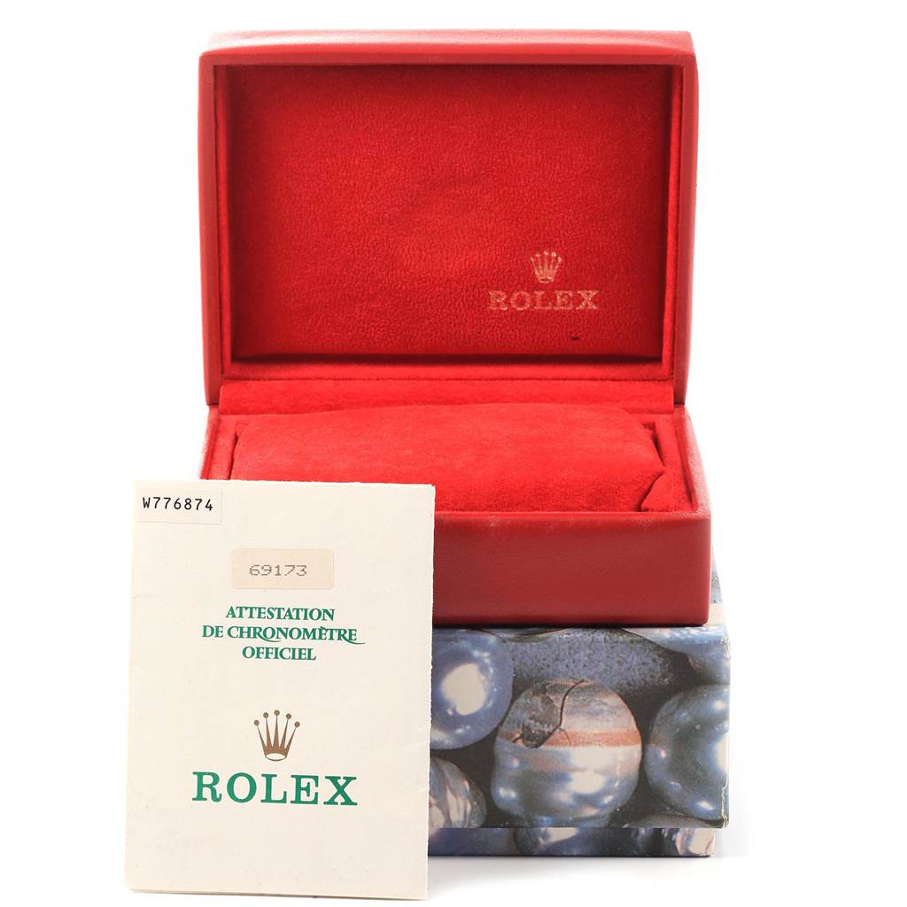 This image shows an open Rolex Datejust 69173 Women's Stainless Steel White Dial 69173 Women's Stainless Steel White Dial watch box with red interior and official certification papers in front.