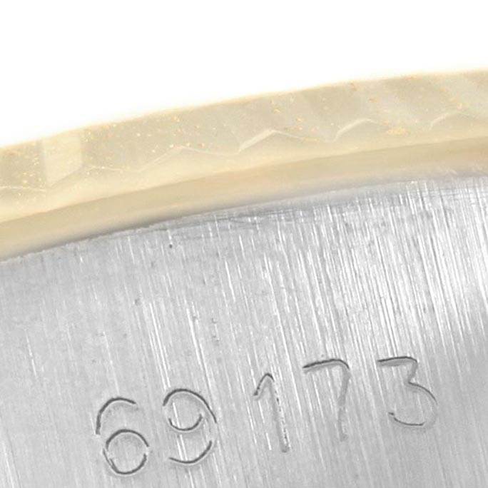 This close-up of a Rolex Datejust 69173 Women's Stainless Steel White Dial 69173 Women's Stainless Steel White Dial watch shows part of the serial number engraved on the case.