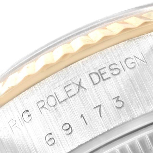 The image shows a close-up of the serial number engraving on the side of the bezel of a Rolex Datejust 69173 Women's Stainless Steel Blue Dial 69173 Women's Stainless Steel Blue Dial watch.
