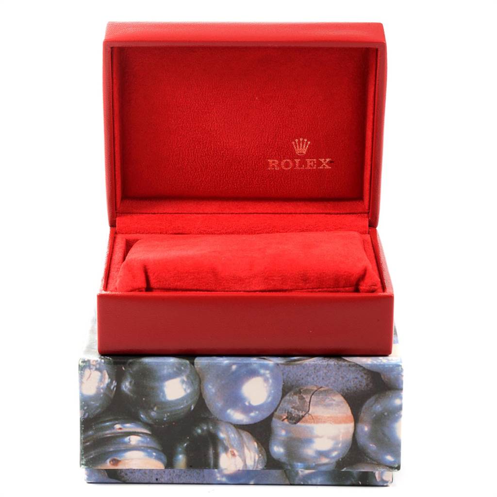 A Rolex Datejust 69173 Women's Stainless Steel Blue Dial 69173 Women's Stainless Steel Blue Dial watch box and cushion are shown from a front angle, highlighting the brand's logo inside the open case.