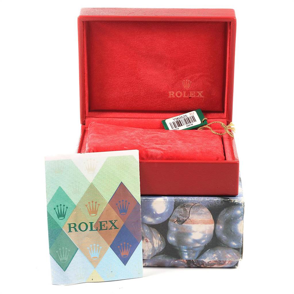 This image shows a closed Rolex Datejust 79174 Women's Stainless Steel Mother of Pearl Dial 79174 Women's Stainless Steel Mother of Pearl Dial watch box with a tag and a Rolex booklet in front.