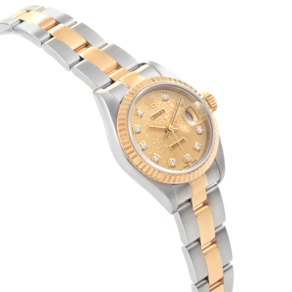 The Rolex Datejust 79173 Women's Stainless Steel Champagne Dial 79173 Women's Stainless Steel Champagne Dial watch is shown at a slight side-angle, highlighting its two-tone bracelet and patterned dial with diamond markers.