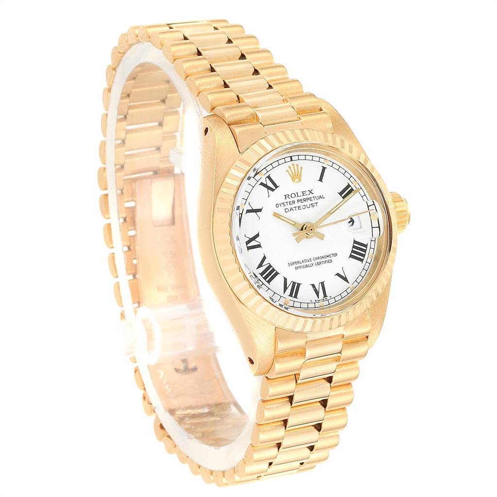 The image shows a Rolex Datejust 6917 Women's Yellow Gold White Dial 6917 Women's Yellow Gold White Dial watch at a three-quarter angle, showcasing its gold bracelet, bezel, and white dial with Roman numerals.