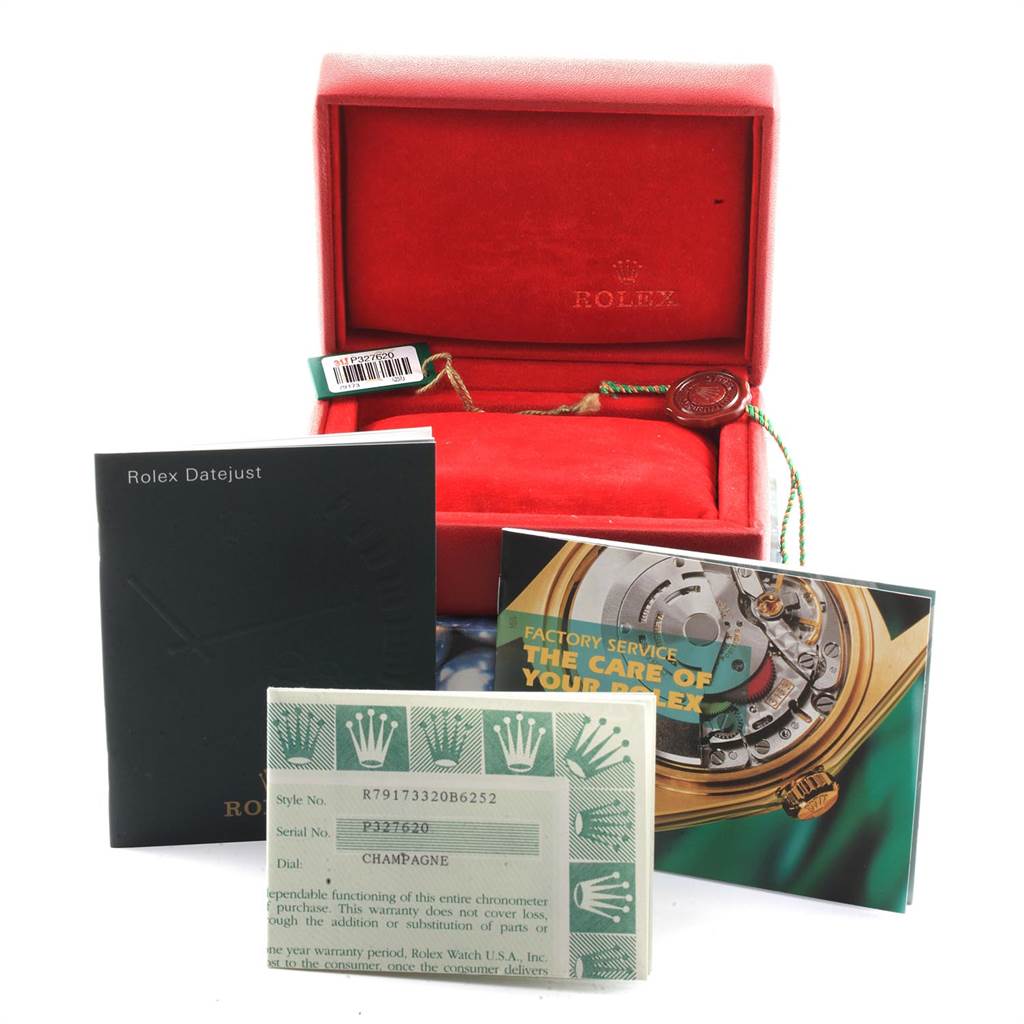 The image shows the accessories of a Rolex Datejust 79173 Women's Steel and Gold (two tone) White Dial 79173 Women's Steel and Gold (two tone) White Dial, including the box, manuals, warranty card, and tag, from a frontal angle.