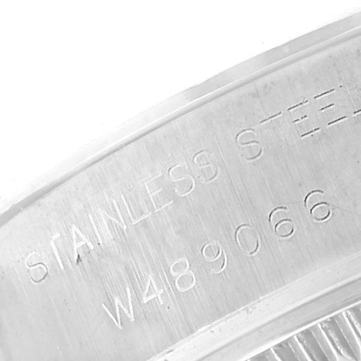 This close-up image shows the stainless steel engraving and serial number on the case back of a Rolex Datejust 69174 Women's Stainless Steel Silver Dial 69174 Women's Stainless Steel Silver Dial watch.