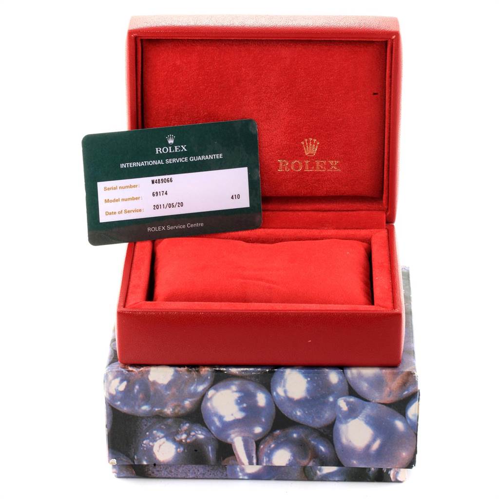 The image displays an empty red Rolex watch box, a red cushion, and an international service guarantee card for a Datejust model.